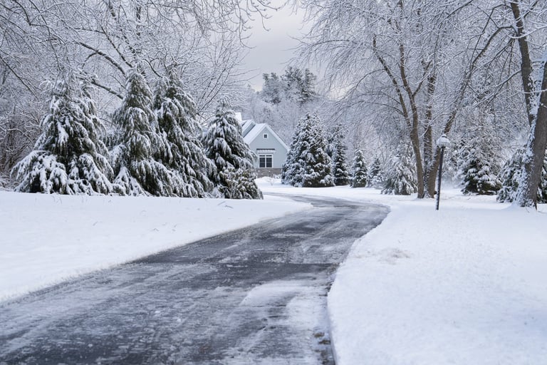 Snow covered driveway and house after winter snowstorm